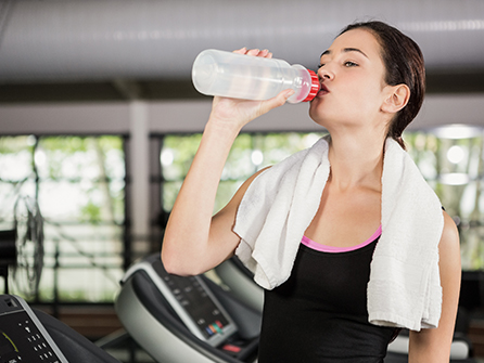 Girl Drinking Water in Gym