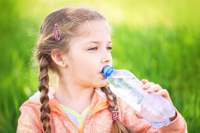 Girl Drinks Water from Bottle
